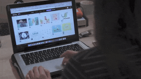 laptop open with a woman scrolling through images