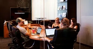 An international team sitting around a conference table.