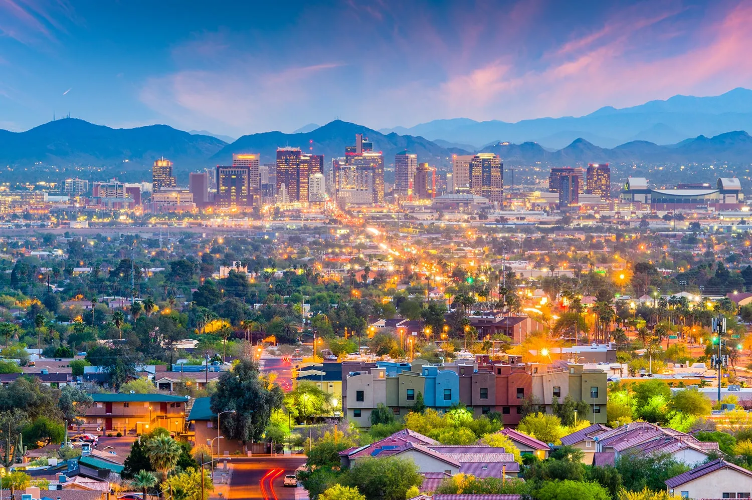 Scenic evening view of downtown Phoenix, Arizona with city lights, skyline, and surrounding mountains