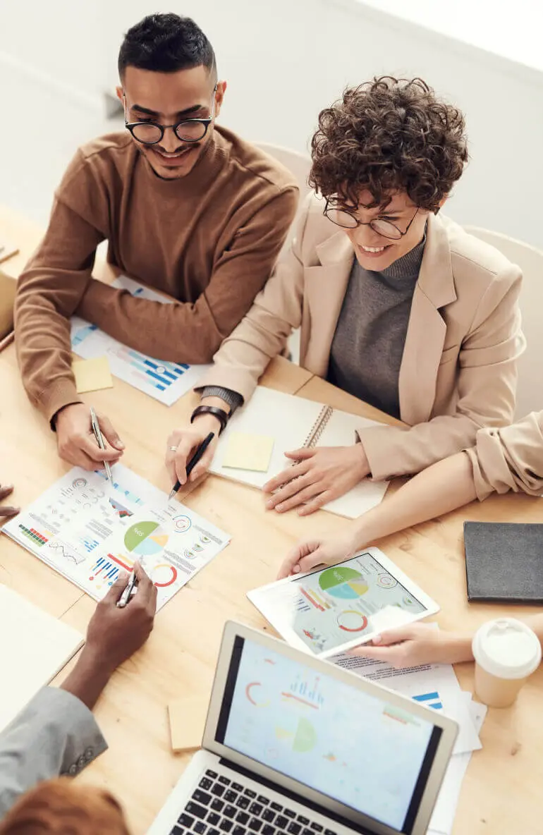 Diverse team reviewing analytics charts and data reports during a meeting